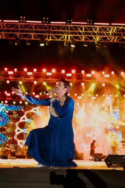 Crowd waving hands with diyas